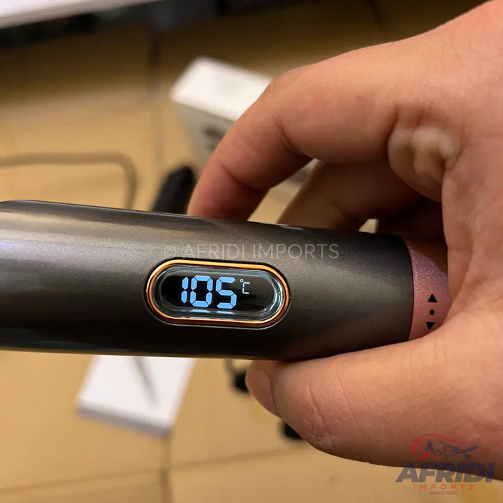A dark gray hair styling tool with a digital display showing ’105°C’ and a rose gold accent ring.