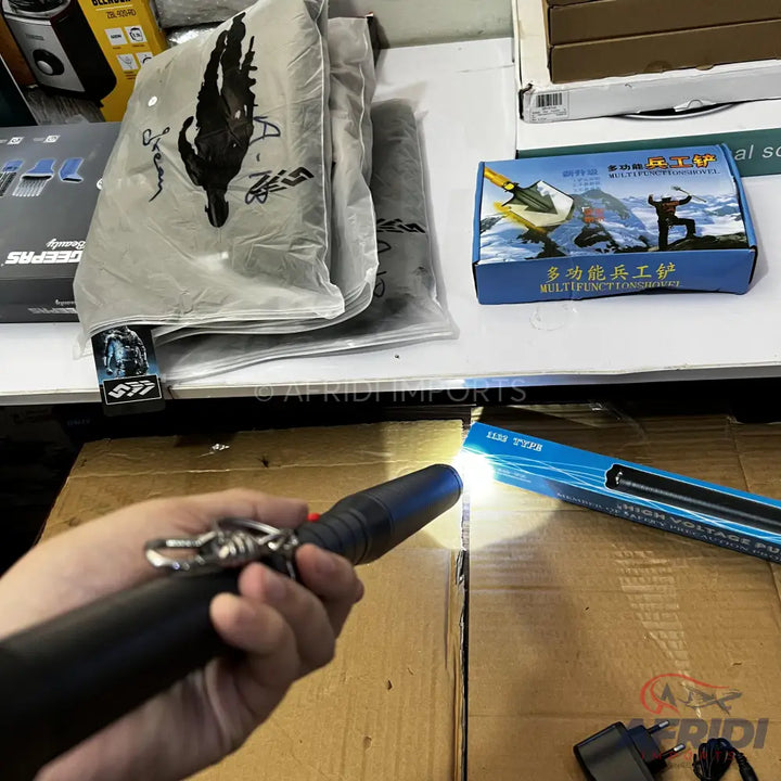 A black tactical flashlight with a bright beam.
