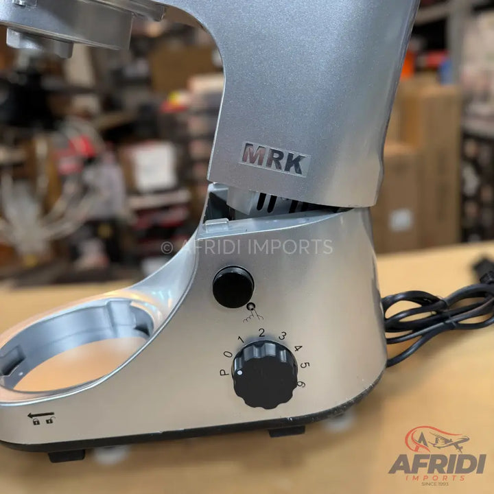 Silver stand mixer with a speed control knob.