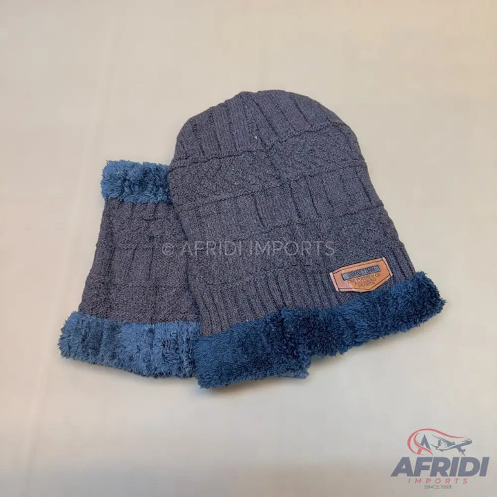 Dark gray knitted beanie and matching neck warmer with blue faux fur lining.