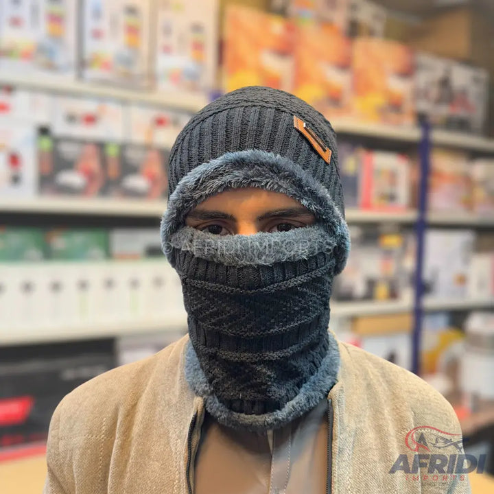 A dark grey knitted winter hat and neck warmer set with a soft, fuzzy lining.