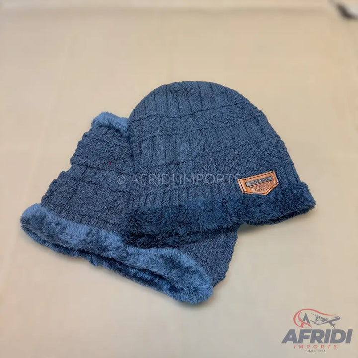 A dark blue knitted beanie hat and neck warmer set with a soft, fuzzy lining.