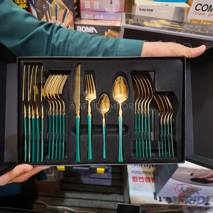 A boxed set of gold and teal colored flatware.