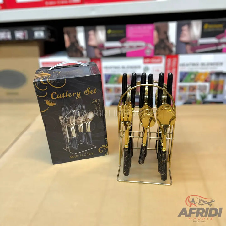A 24-piece black and gold cutlery set with a matching stand.