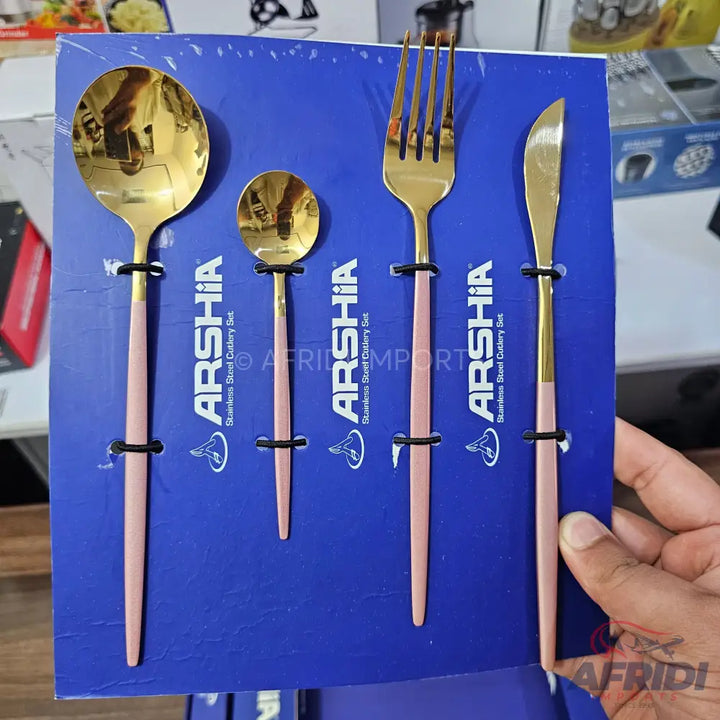 A four-piece set of gold and pink stainless steel cutlery.