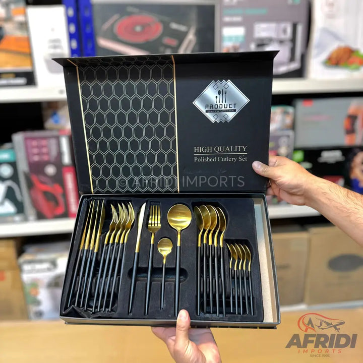 A black and gold polished cutlery set in a display box.