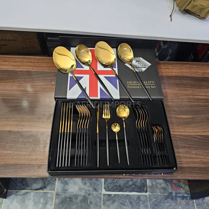 A boxed set of black and gold polished cutlery.