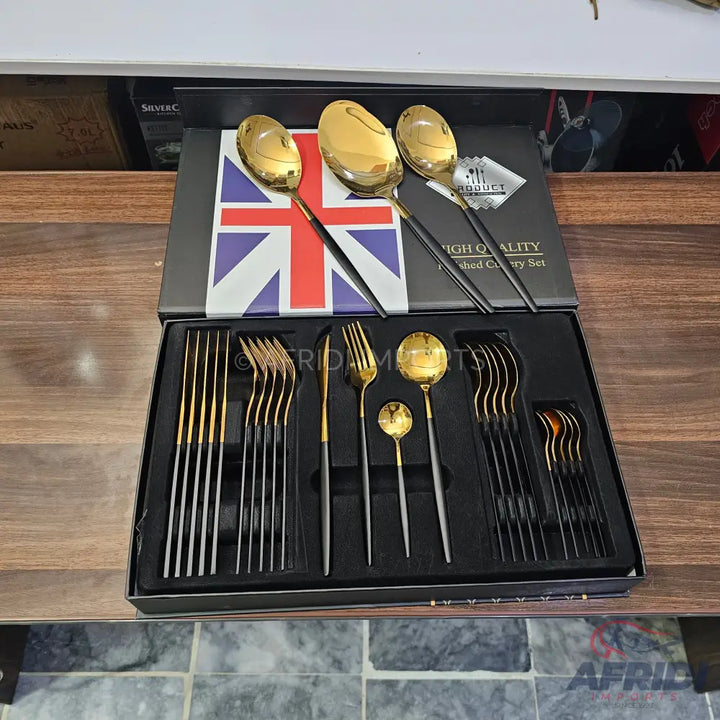 A boxed set of black and gold modern cutlery.