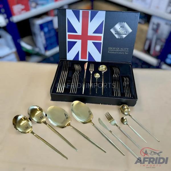 A gold-colored, high-quality, polished cutlery set with various serving utensils.