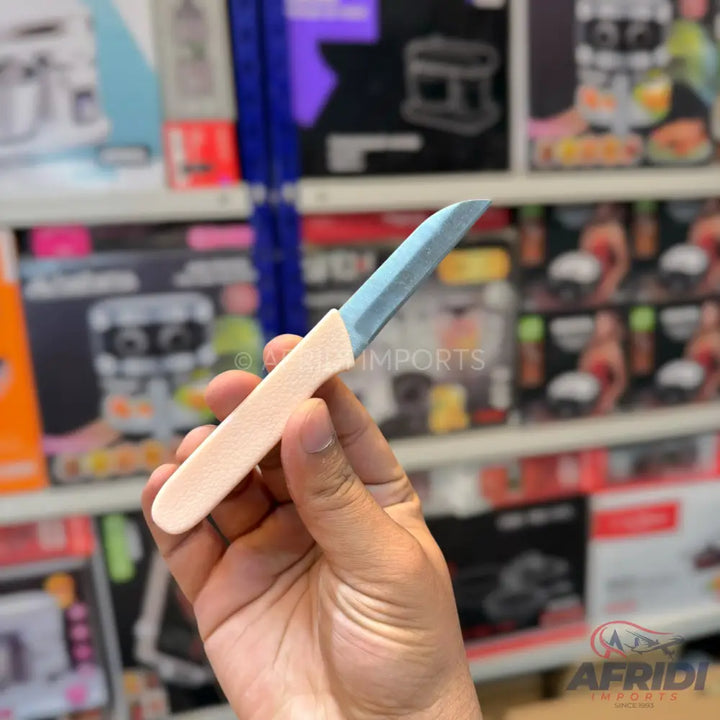 A paring knife with a light blue blade and a light pink handle.
