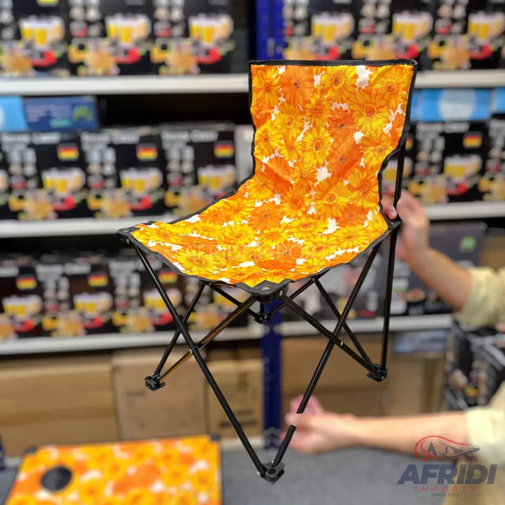 An orange and yellow floral-patterned portable folding chair.