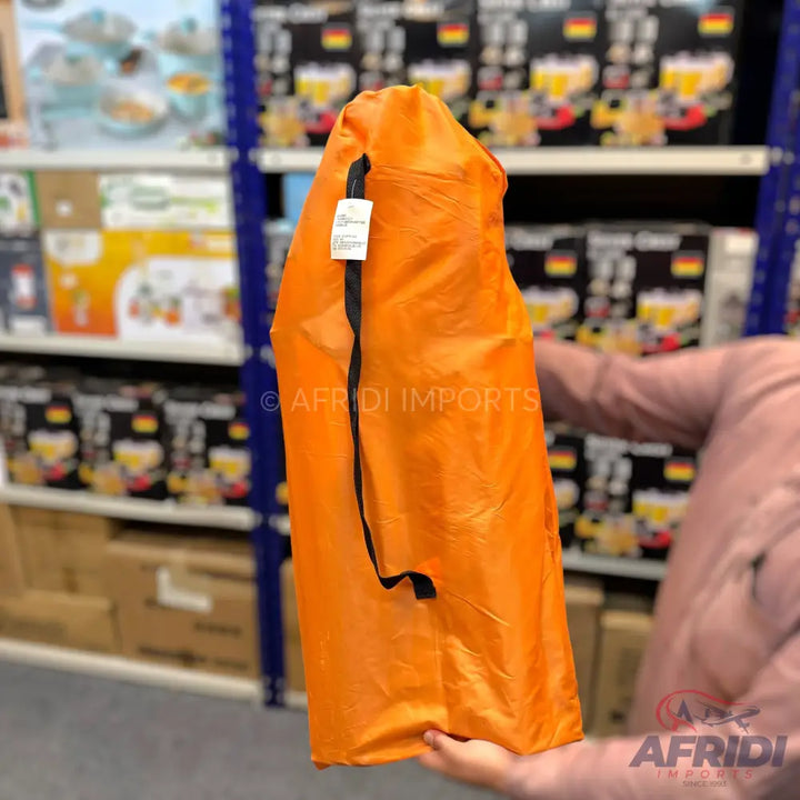 An orange fabric bag with a black drawstring.