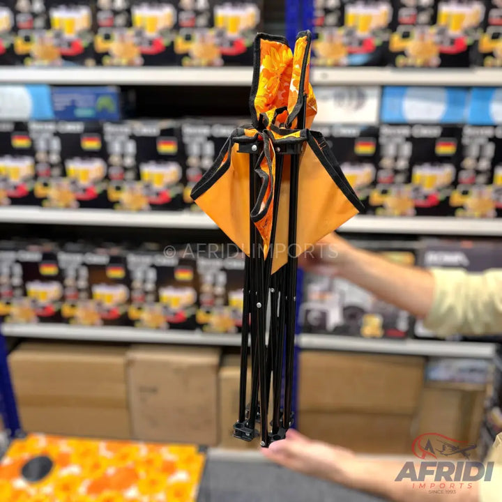 Foldable orange and black portable cornhole game set.