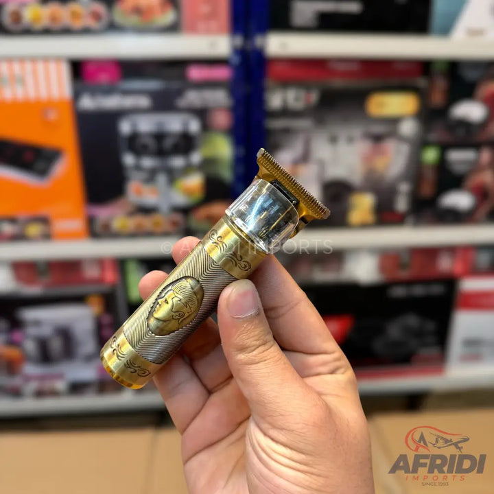 Gold and silver patterned cordless hair trimmer.
