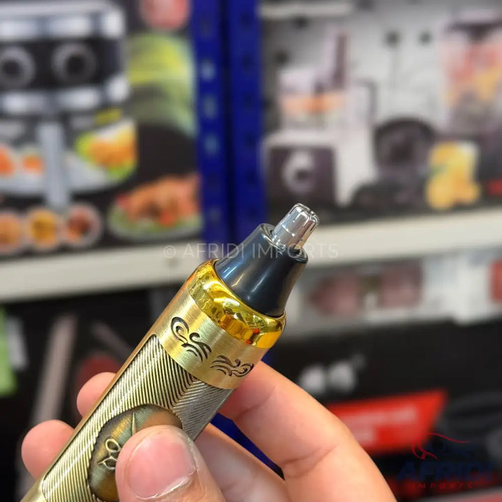 Gold and silver-toned electric nose hair trimmer with a clear protective cap.