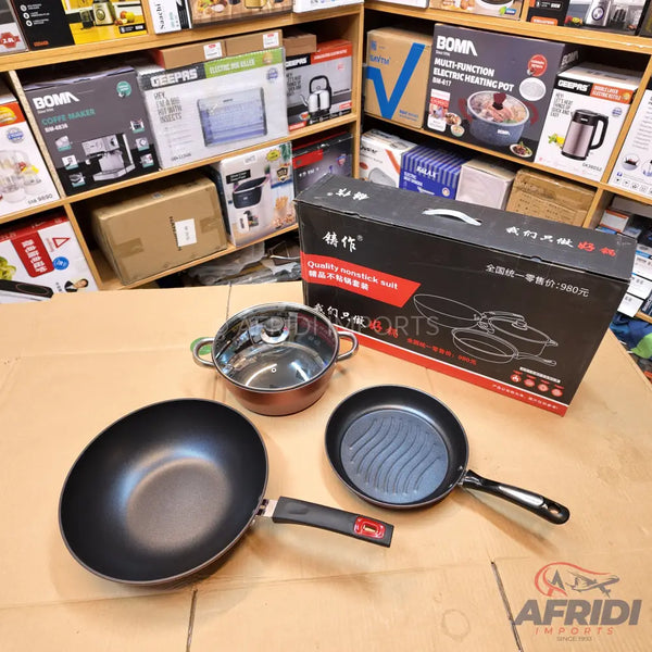 A set of cookware, including a nonstick wok, a grill pan, and a pot with a glass lid.
