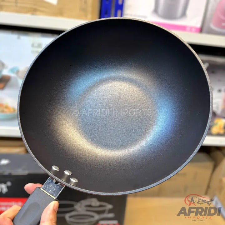 Black non-stick wok with a handle.