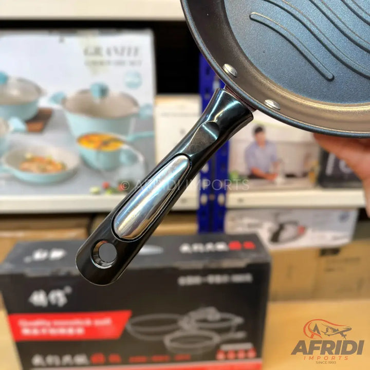 Black non-stick frying pan with a silver-accented handle.