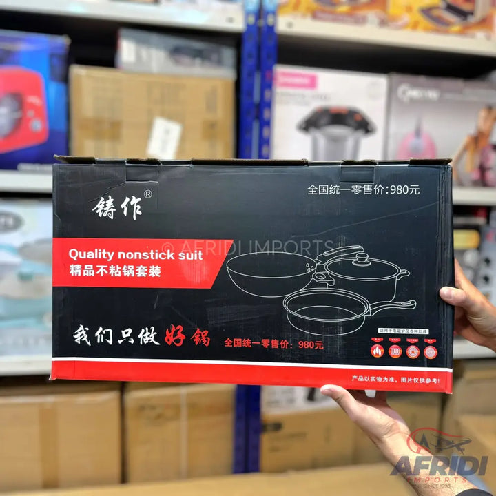 Black box of a nonstick cookware set with line drawings of a wok, pot, and frying pan.