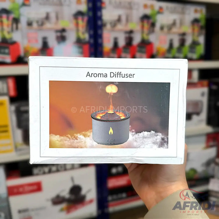 A white box for an aroma diffuser, featuring a graphic of the diffuser producing a flame-like vapor and surrounded by mist.