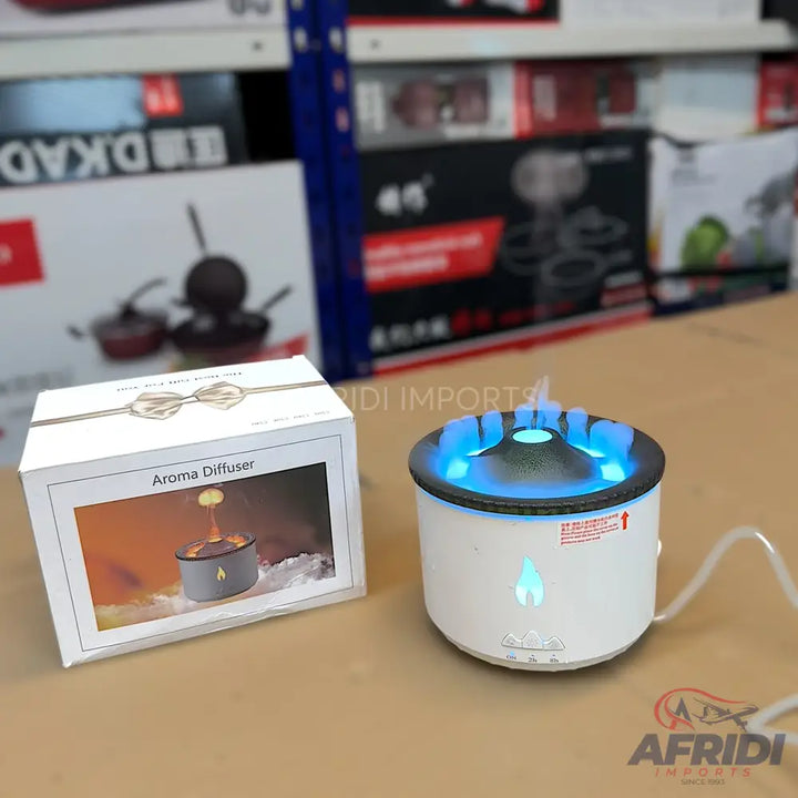 White aroma diffuser with blue LED light and a flame-like mist effect.