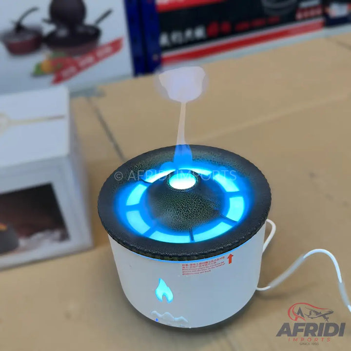 White ultrasonic humidifier with blue LED light and a flame-shaped indicator.