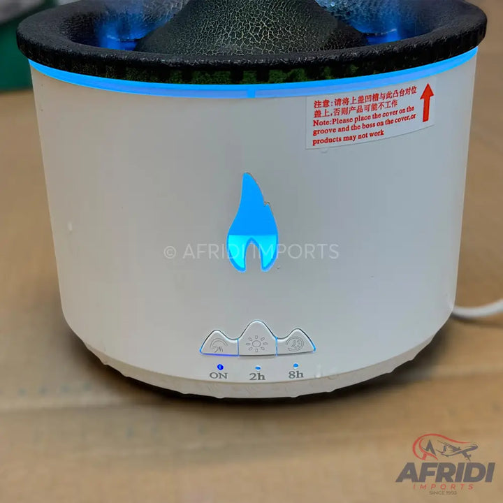 White humidifier with a blue flame-like light and timer settings.