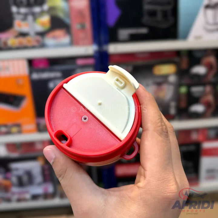 A red and white round plastic lid with a flip-top opening, designed for a container.