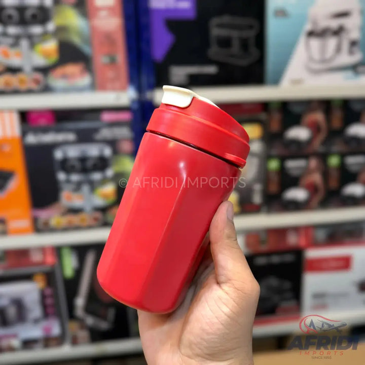 Red hexagonal water bottle with a white flip-top lid.