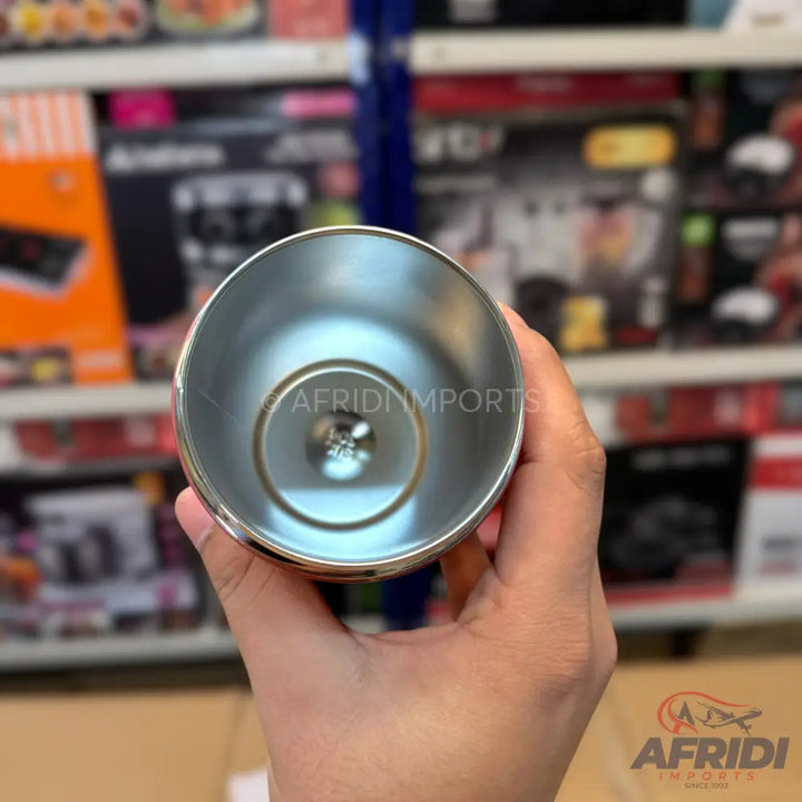 Stainless steel tumbler with a reflective interior.