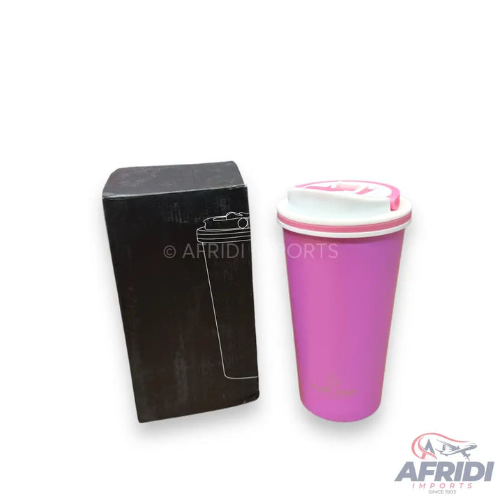 A pink travel mug with a white lid and a black box.
