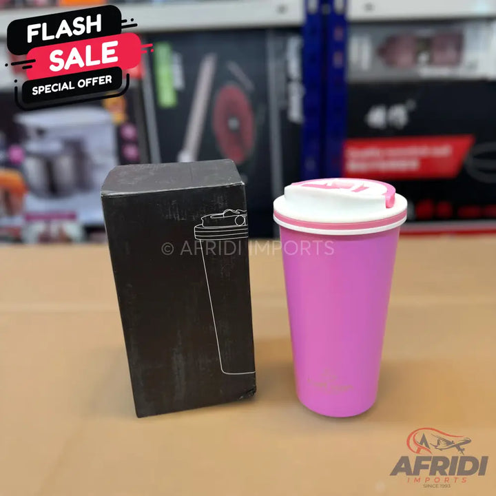 Pink travel mug with a white lid and a black box.