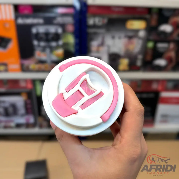 A white and pink plastic tumbler lid with a built-in handle.