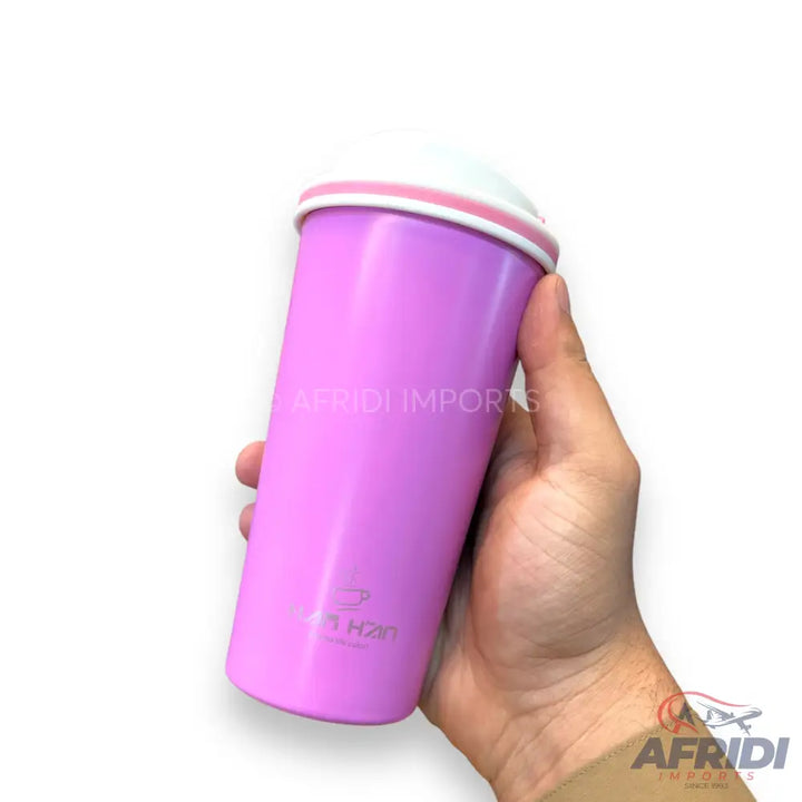 A pink travel mug with a white lid and a light pink rim.