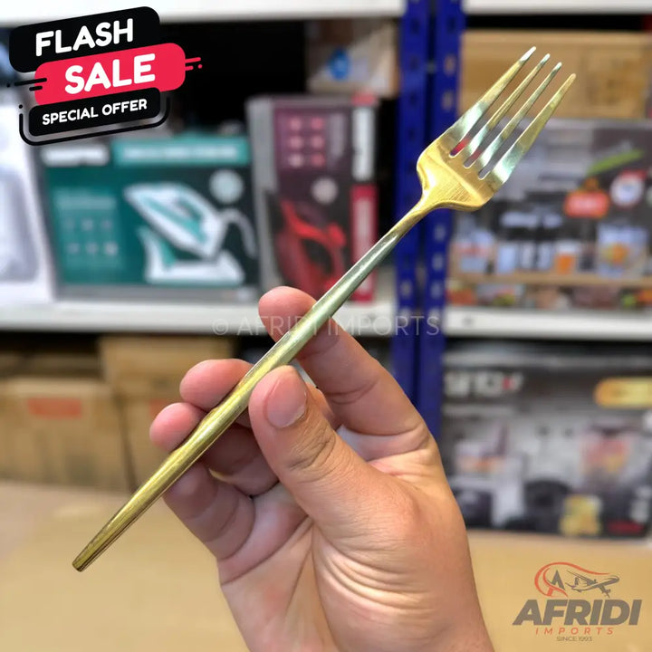 A shiny gold-colored metal dinner fork.