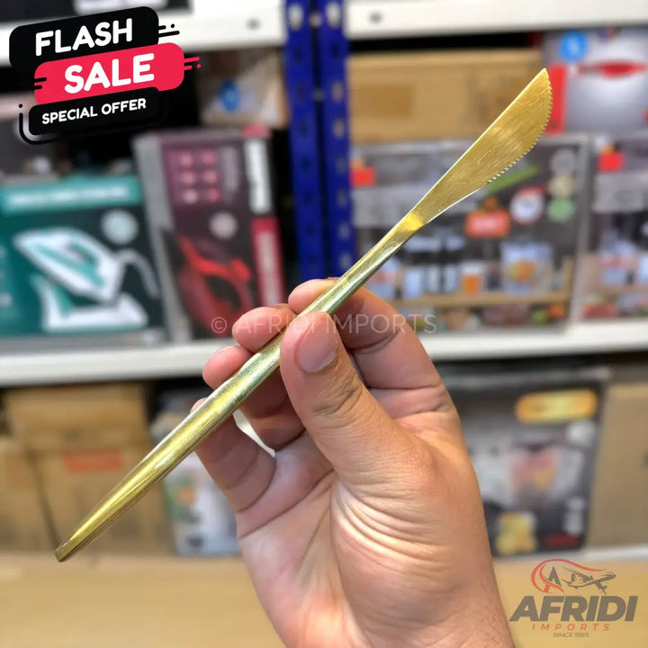 A golden serrated butter knife.