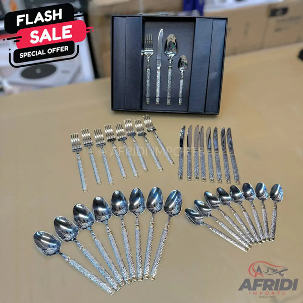 A complete set of ornate, silver-colored flatware.