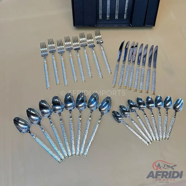 A complete set of shiny, metallic cutlery with textured handles.