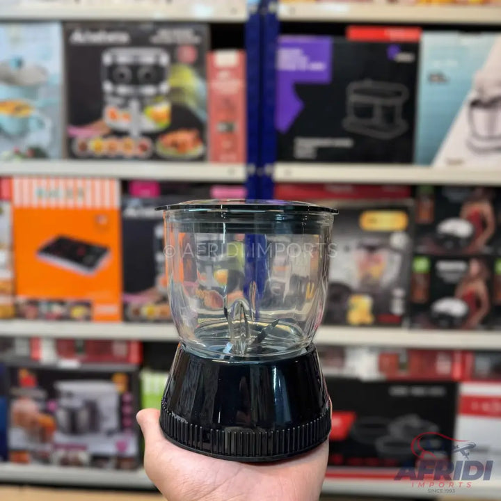 A compact, personal-sized blender with a clear plastic cup, a black base, and visible blades.