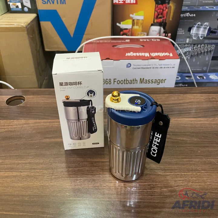 Stainless steel coffee mug with a blue lid and a digital temperature display.