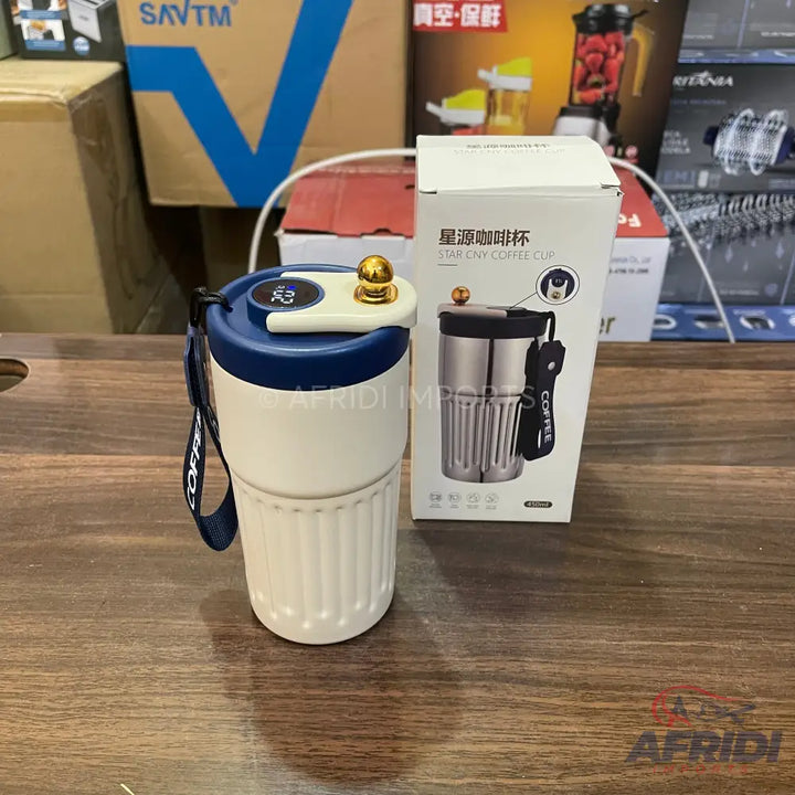 White and blue portable coffee grinder and cup combination.