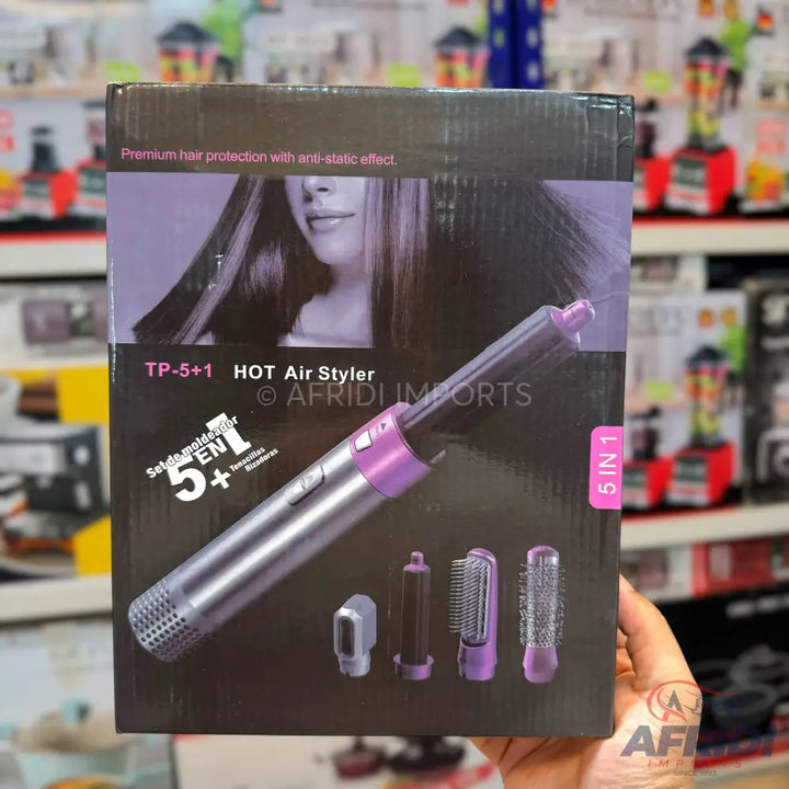 Hair styler with multiple attachments for drying, curling, and brushing.