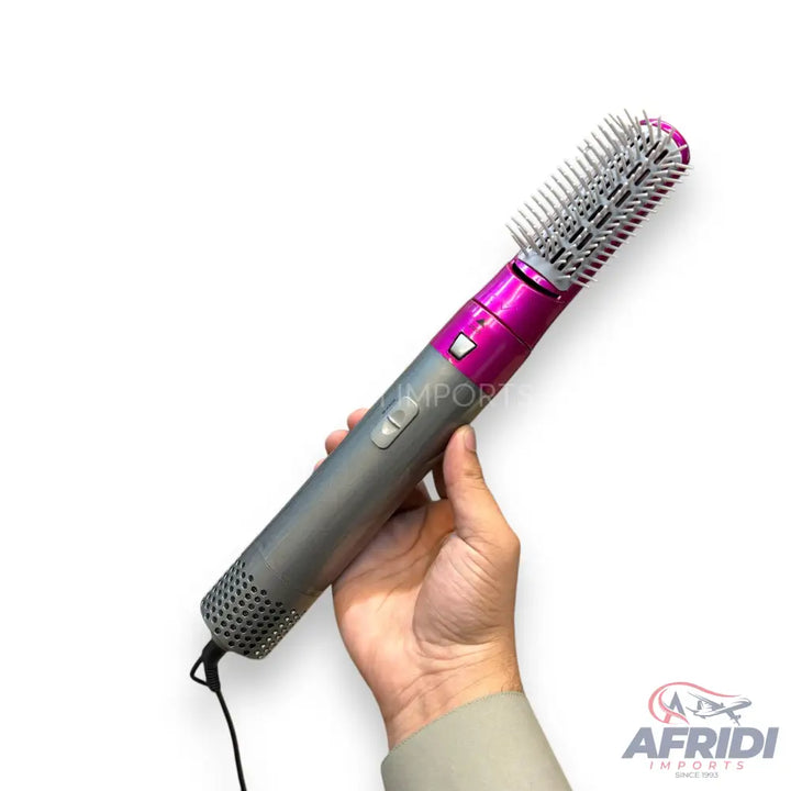 Pink and grey hair styling tool with a brush attachment and visible controls.