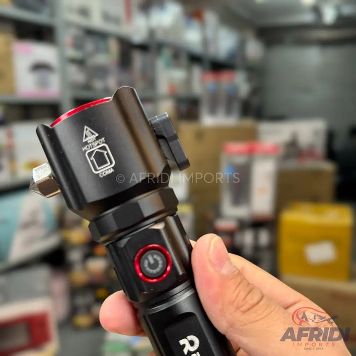 Black multi-functional flashlight with a red power button and a side-mounted accessory.
