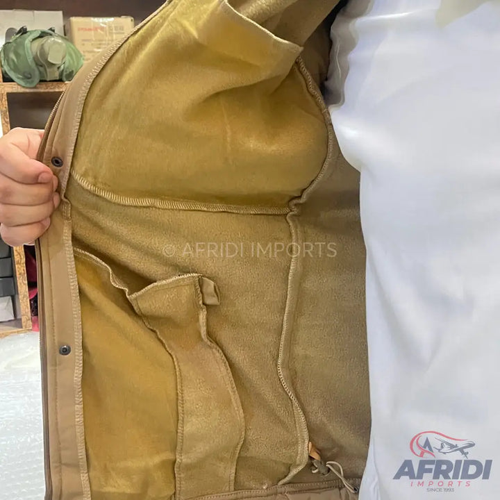 The interior of a tan jacket with multiple pockets.