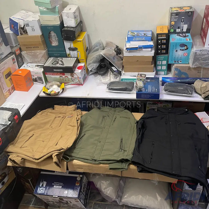Three tactical jackets in tan, olive green, and black.