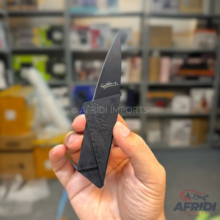 A sleek black folding pocket knife with a textured handle.