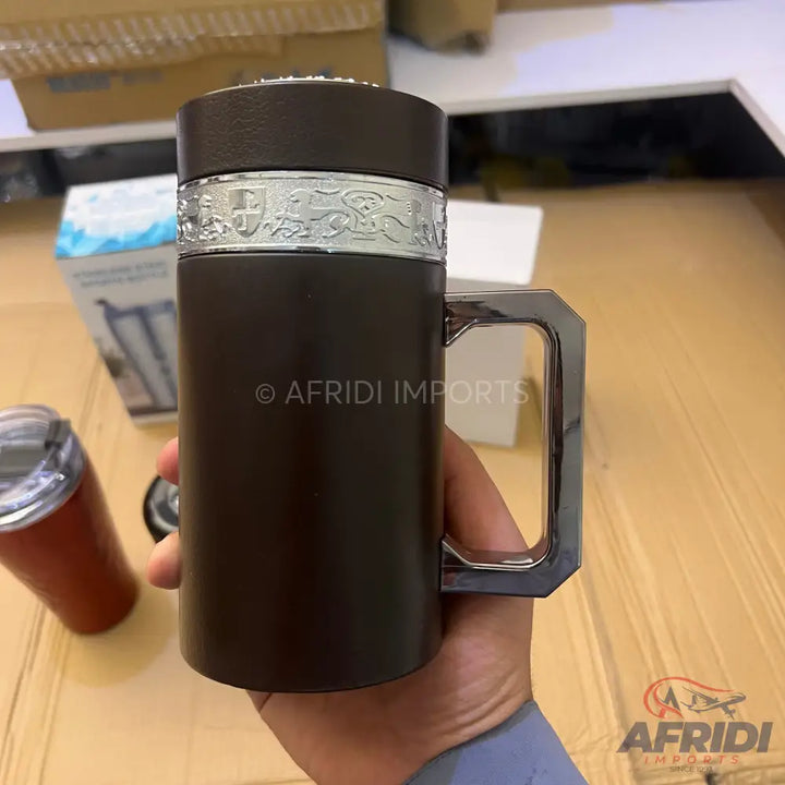 Dark brown travel mug with a silver decorative band and a polished silver-colored handle.