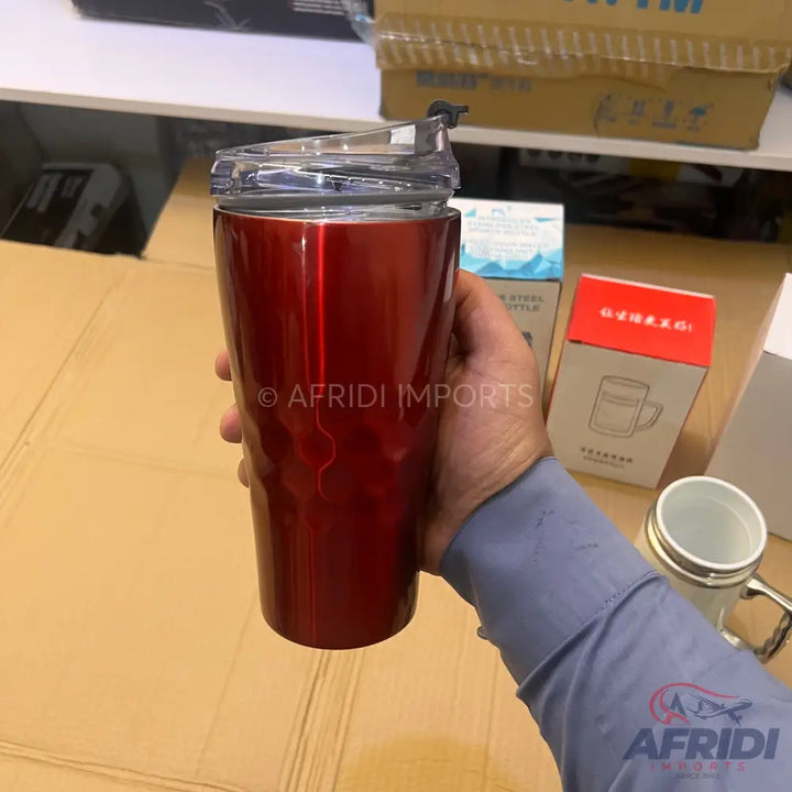 Red metallic travel mug with a clear, spill-proof lid.