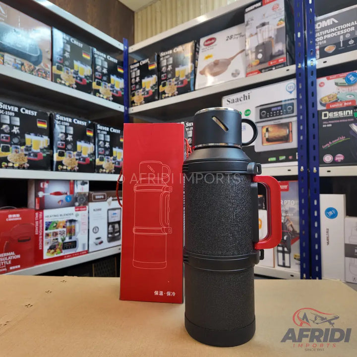 Black insulated water bottle with a red handle and a drinking cup.